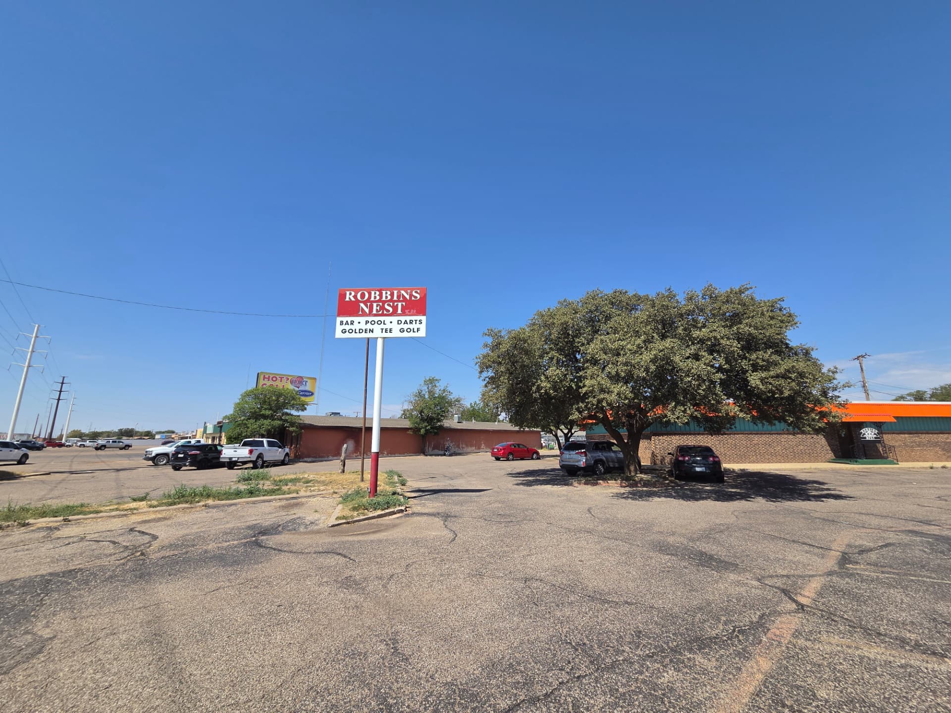 Robbins Nest parking lot and street sign on a clear Lubbock day