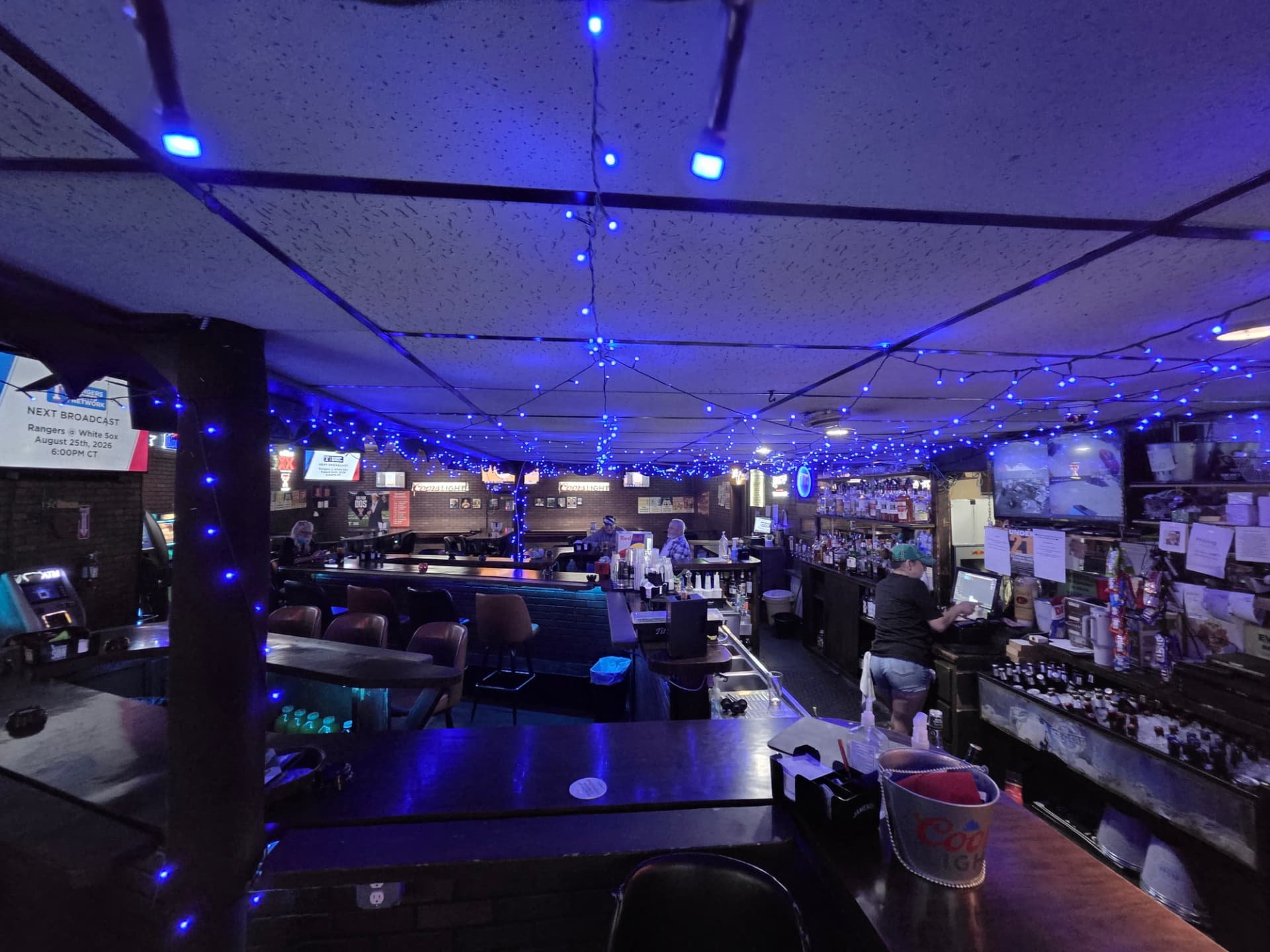 The main bar at Robbins Nest under blue string lights