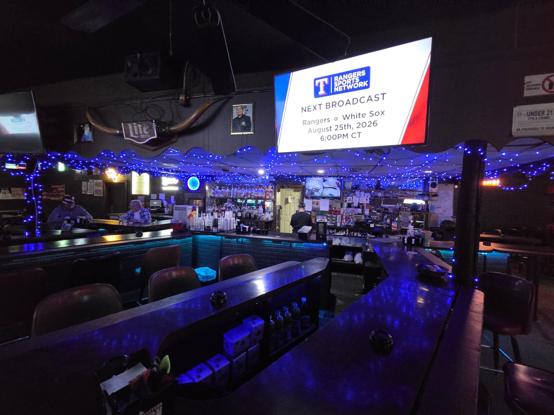 Game day on the big screen over the bar with regulars in their seats