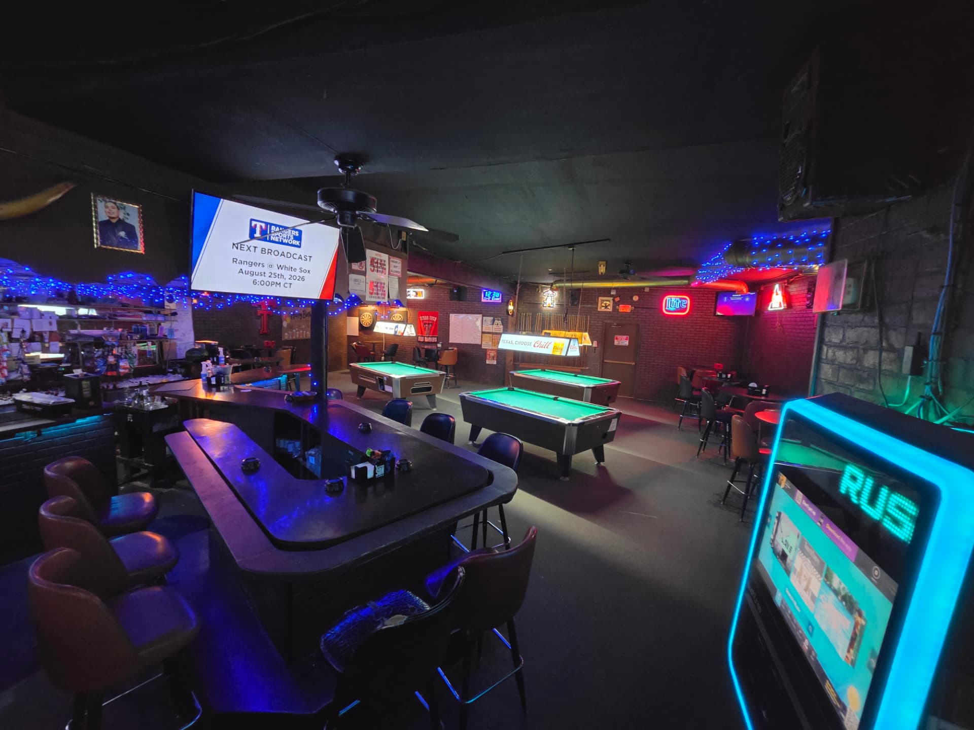 The horseshoe bar looking back toward the pool tables and game screens