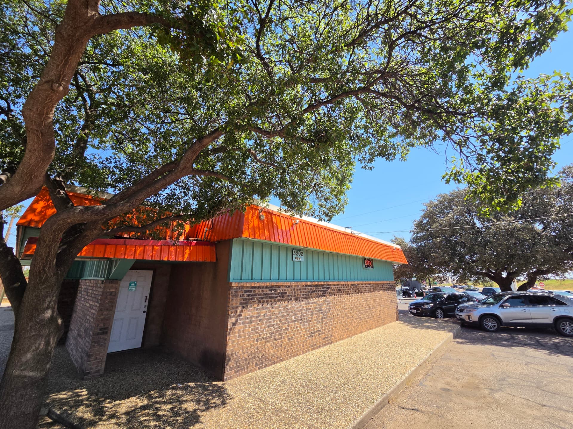 Side entrance at 5202 with the open sign in the window