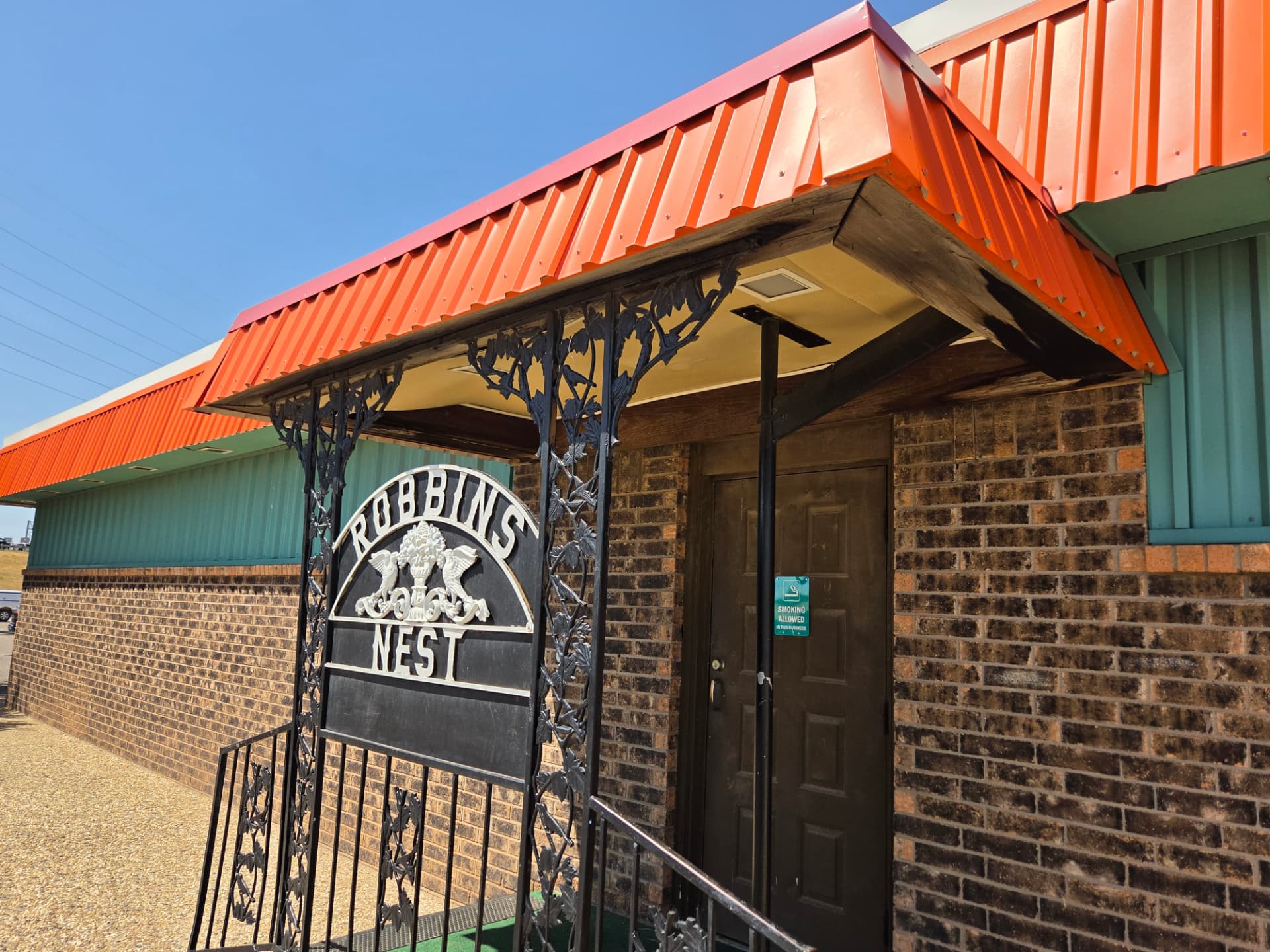 Front door of Robbins Nest under the orange metal awning